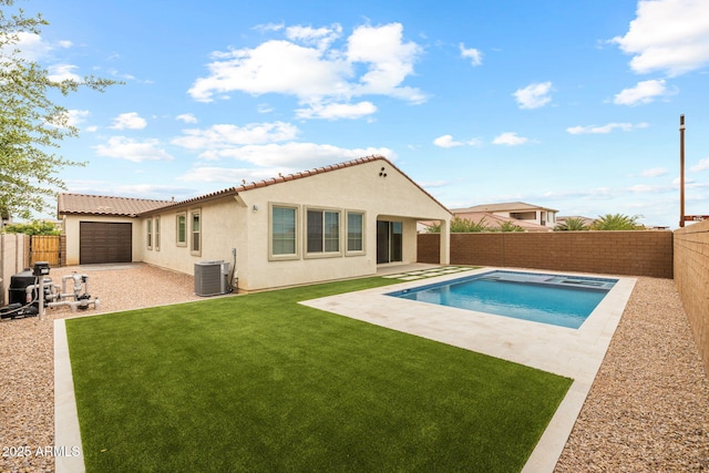 rear view of house with stucco siding, a patio area, a tiled roof, and central AC unit