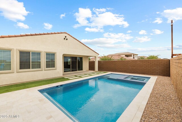 view of pool featuring a fenced backyard, a patio area, and a pool with connected hot tub
