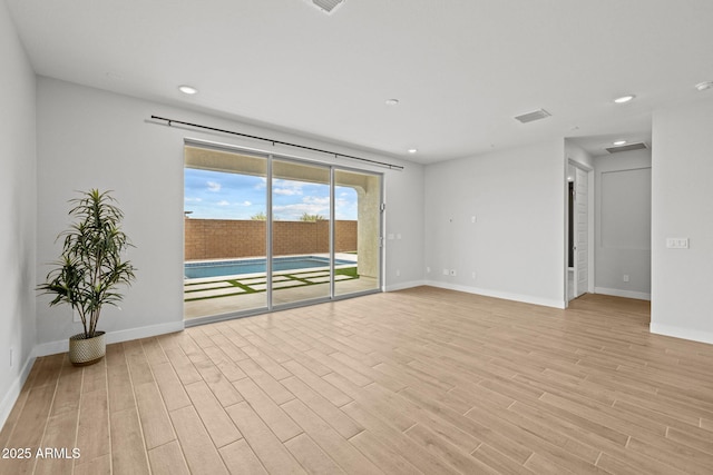 unfurnished room featuring light wood-style floors, baseboards, and recessed lighting