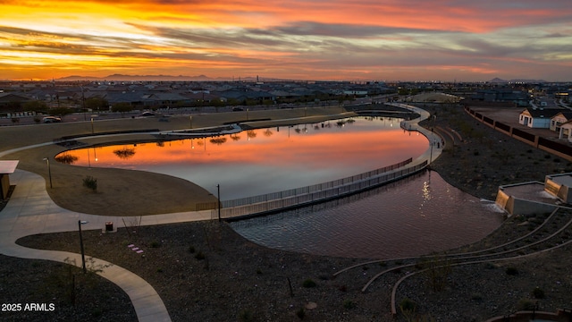pool at dusk featuring a residential view