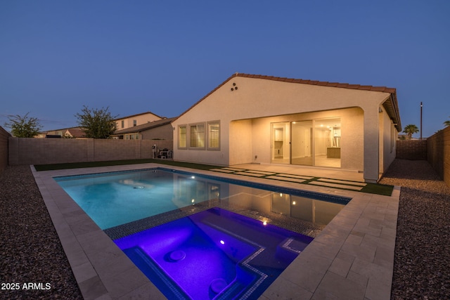 view of swimming pool featuring an in-ground hot tub, a fenced backyard, and a patio area