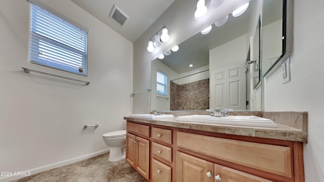 bathroom featuring a shower, vanity, toilet, and lofted ceiling