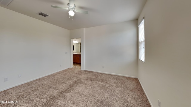 unfurnished room featuring light carpet and ceiling fan