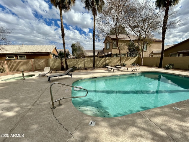 view of pool featuring an in ground hot tub and a patio