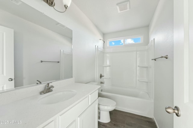 full bath with shower / washtub combination, visible vents, toilet, vanity, and wood finished floors