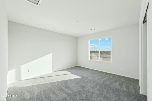 unfurnished bedroom with carpet floors, visible vents, and baseboards