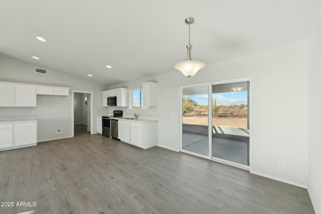 kitchen featuring light countertops, visible vents, appliances with stainless steel finishes, a sink, and wood finished floors