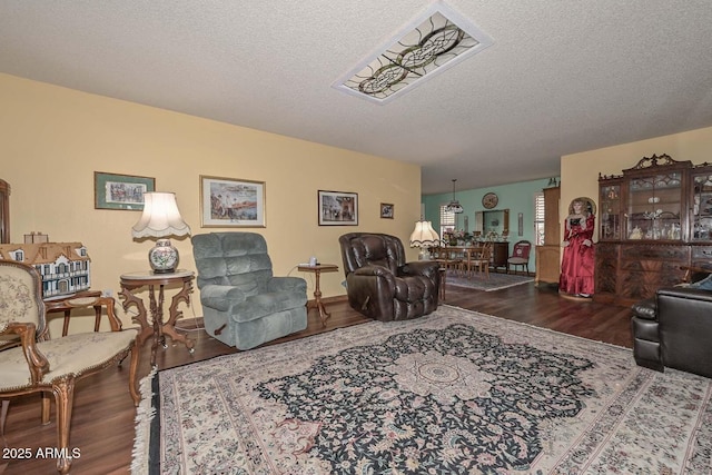 living room with a textured ceiling and wood finished floors