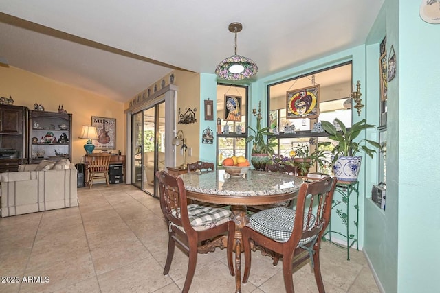 dining space with french doors and vaulted ceiling