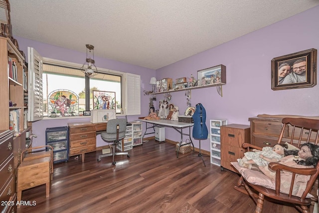 office featuring wood finished floors, baseboards, and a textured ceiling