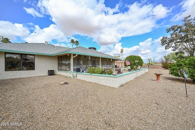 back of property featuring stucco siding and a sunroom