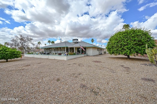 back of property featuring glass enclosure