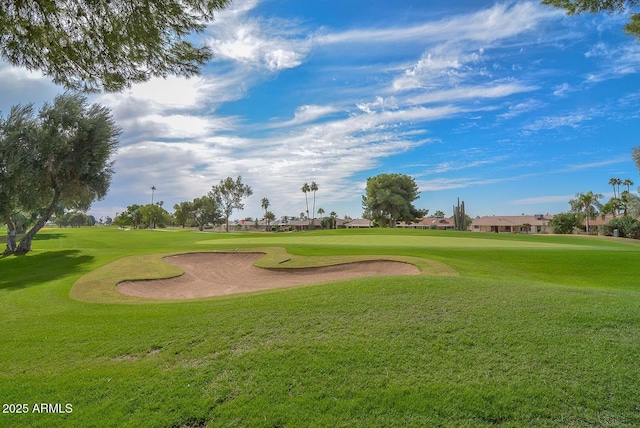 view of home's community with view of golf course and a yard