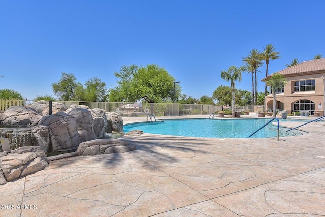 view of pool with a fenced in pool, a patio, and fence