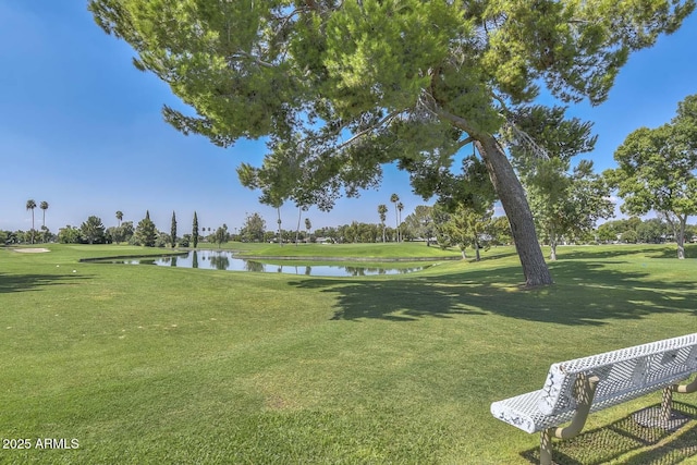 view of property's community with a yard and a water view