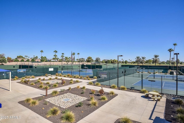 view of sport court featuring fence