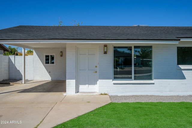 view of exterior entry featuring a carport