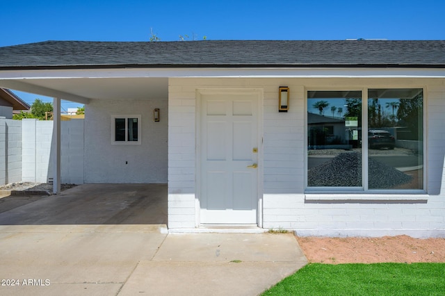 property entrance with a carport