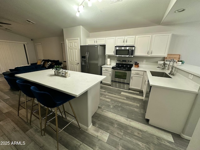6920 S 46th Dr, Laveen, AZ 85339 - kitchen featuring appliances with stainless steel finishes, a sink, light countertops, and white cabinets