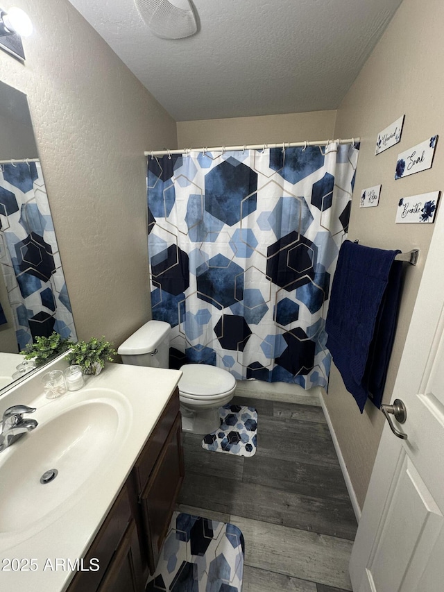 6920 S 46th Dr, Laveen, AZ 85339 - full bath featuring vanity, a textured ceiling, wood finished floors, toilet, and a textured wall