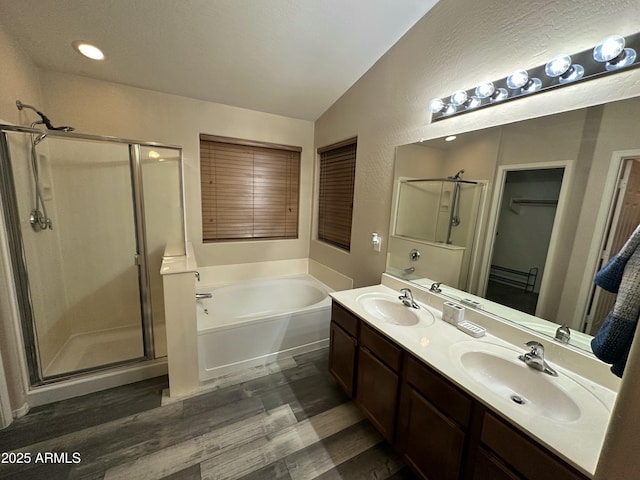 6920 S 46th Dr, Laveen, AZ 85339 - full bath with a stall shower, a bath, wood finished floors, vaulted ceiling, and double vanity