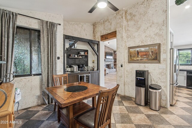 21131 E Excelsior Ave, Queen Creek, AZ 85142 - dining space with beverage cooler, a ceiling fan, and light stone finish flooring