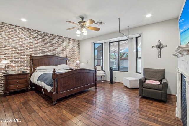 21131 E Excelsior Ave, Queen Creek, AZ 85142 - bedroom featuring a fireplace, brick wall, multiple windows, wood finished floors, and ceiling fan