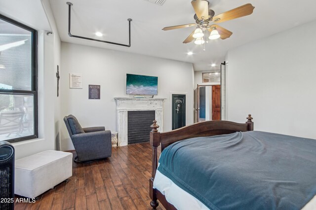 21131 E Excelsior Ave, Queen Creek, AZ 85142 - bedroom with hardwood / wood-style flooring, a fireplace, recessed lighting, and a ceiling fan