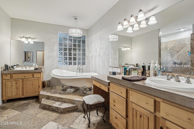 21131 E Excelsior Ave, Queen Creek, AZ 85142 - bathroom with two vanities, a soaking tub, a tile shower, and stone tile floors