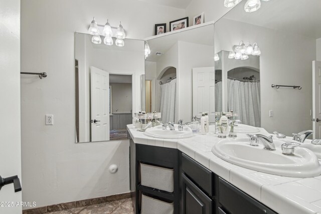 21131 E Excelsior Ave, Queen Creek, AZ 85142 - full bathroom featuring double vanity, tile patterned floors, a chandelier, and a shower with shower curtain