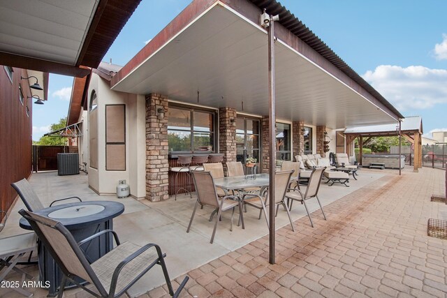 21131 E Excelsior Ave, Queen Creek, AZ 85142 - view of patio featuring a hot tub, central AC unit, and outdoor dining space