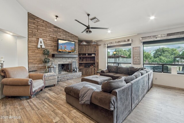 21131 E Excelsior Ave, Queen Creek, AZ 85142 - living area with a ceiling fan, a large fireplace, light wood-type flooring, and lofted ceiling