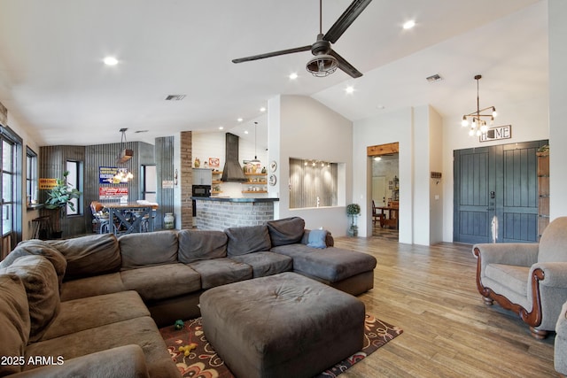 21131 E Excelsior Ave, Queen Creek, AZ 85142 - living area featuring a chandelier, ceiling fan, wood finished floors, high vaulted ceiling, and recessed lighting