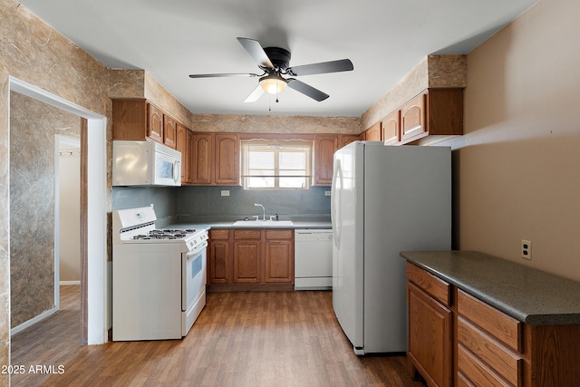 841 W Spray St, Superior, AZ 85173 - kitchen featuring white appliances, a ceiling fan, wood finished floors, and brown cabinets