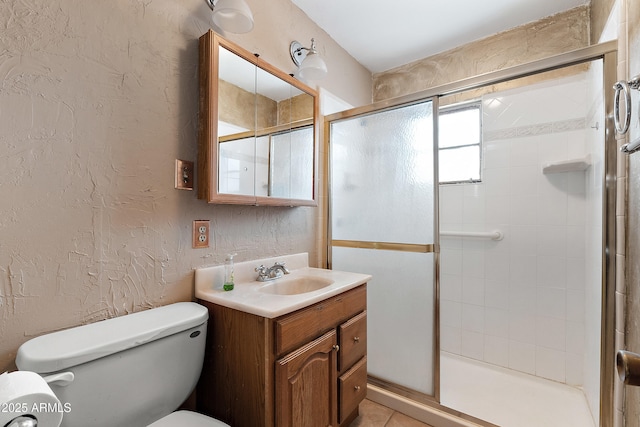 841 W Spray St, Superior, AZ 85173 - bathroom featuring a textured wall, toilet, vanity, a shower stall, and tile patterned floors