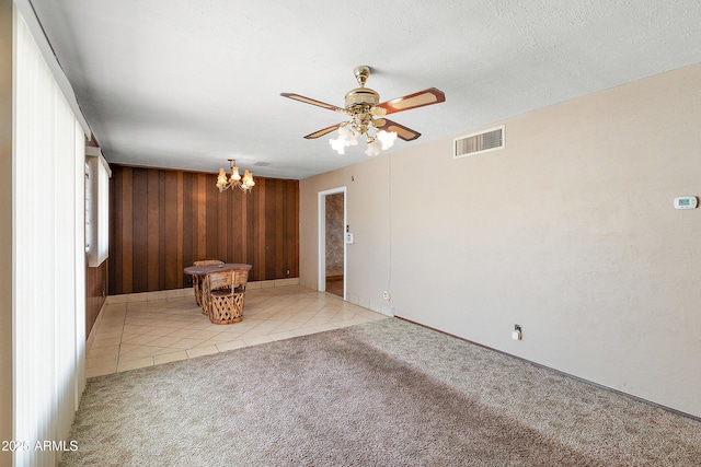 841 W Spray St, Superior, AZ 85173 - unfurnished living room featuring carpet floors, wooden walls, a chandelier, ceiling fan, and baseboards