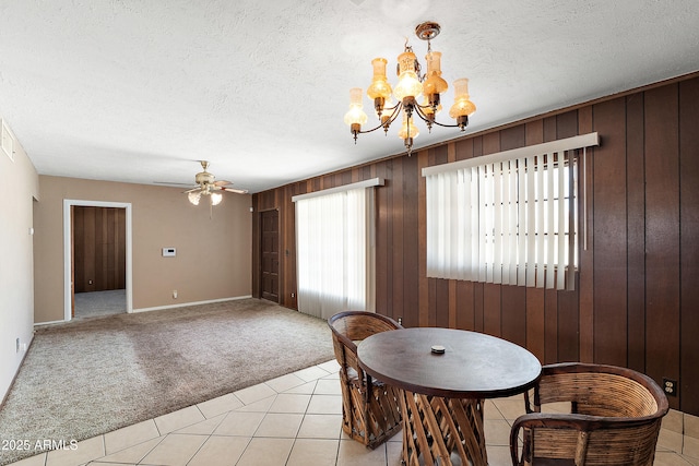 841 W Spray St, Superior, AZ 85173 - dining space featuring light colored carpet, a chandelier, wooden walls, a ceiling fan, and a textured ceiling