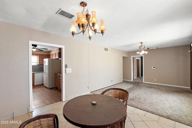 841 W Spray St, Superior, AZ 85173 - dining room with ceiling fan, a chandelier, light tile patterned floors, and light carpet