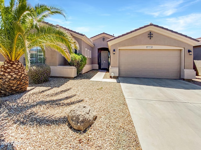 18207 W Marshall Ln, Surprise, AZ 85388 - mediterranean / spanish-style home featuring a garage, stucco siding, concrete driveway, and a tiled roof