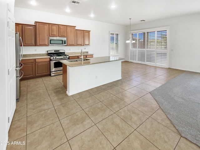 18207 W Marshall Ln, Surprise, AZ 85388 - kitchen featuring visible vents, an island with sink, a sink, appliances with stainless steel finishes, and light tile patterned floors