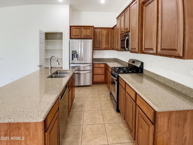 18207 W Marshall Ln, Surprise, AZ 85388 - kitchen featuring stainless steel appliances, light stone counters, brown cabinetry, and a sink