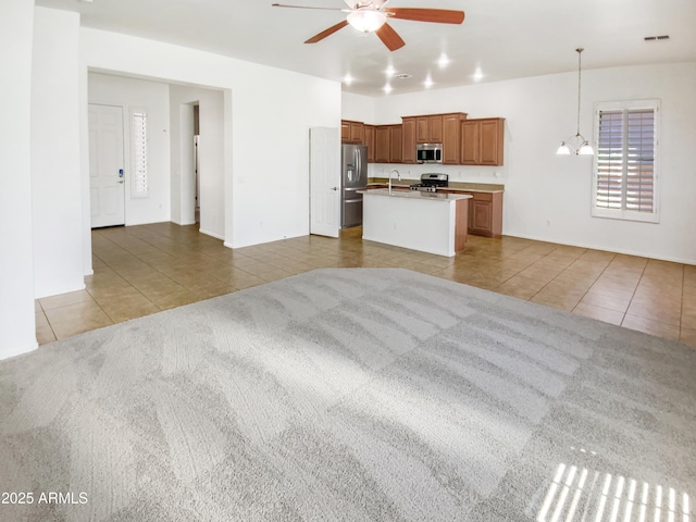 18207 W Marshall Ln, Surprise, AZ 85388 - unfurnished living room with tile patterned floors, visible vents, a sink, and ceiling fan with notable chandelier