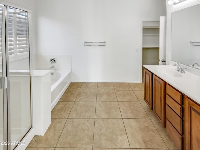 18207 W Marshall Ln, Surprise, AZ 85388 - bathroom with vanity, tile patterned floors, baseboards, a garden tub, and a stall shower