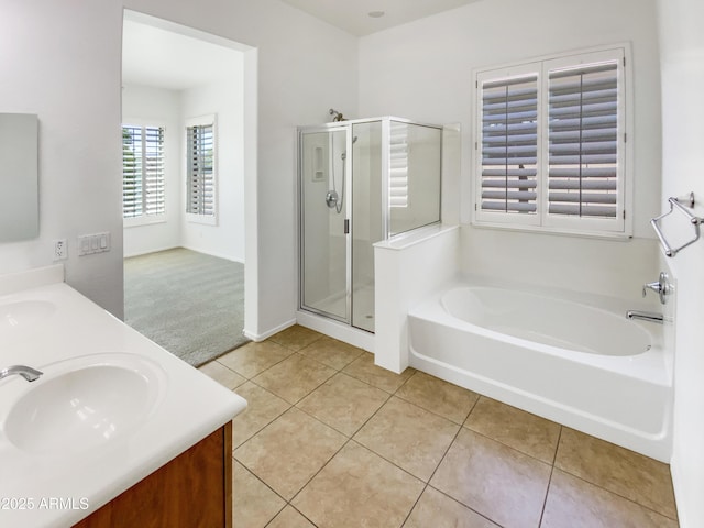 18207 W Marshall Ln, Surprise, AZ 85388 - bathroom featuring double vanity, a garden tub, a shower stall, a sink, and tile patterned floors