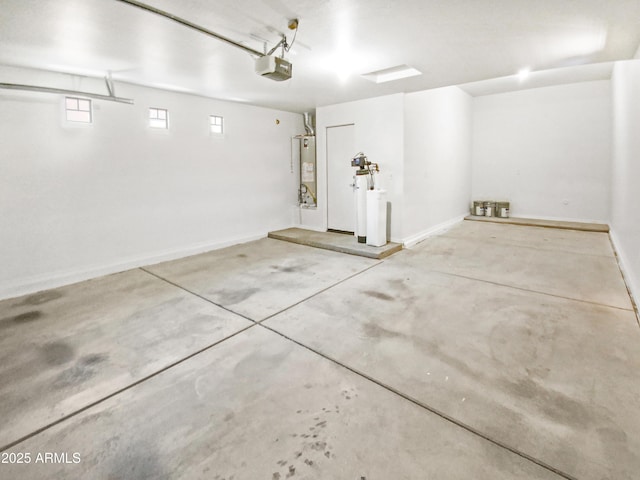 18207 W Marshall Ln, Surprise, AZ 85388 - garage with baseboards, a garage door opener, and gas water heater