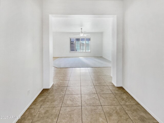 18207 W Marshall Ln, Surprise, AZ 85388 - carpeted spare room featuring tile patterned floors, ceiling fan, and baseboards