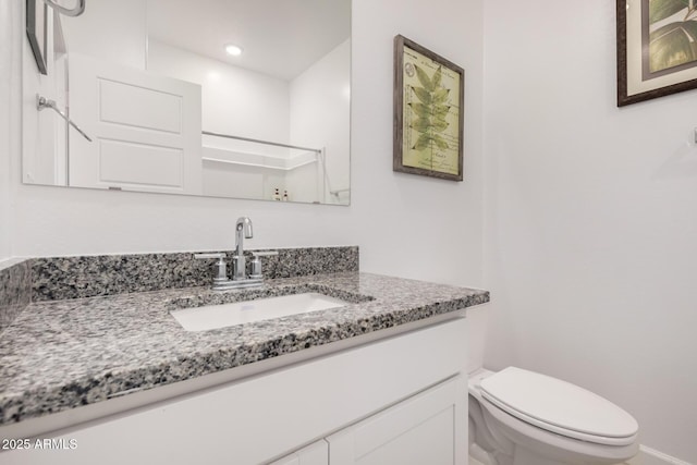 bathroom featuring vanity and toilet