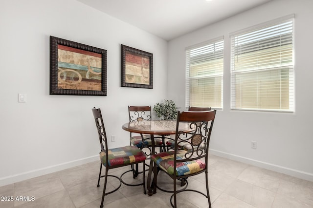 dining space featuring light tile patterned floors