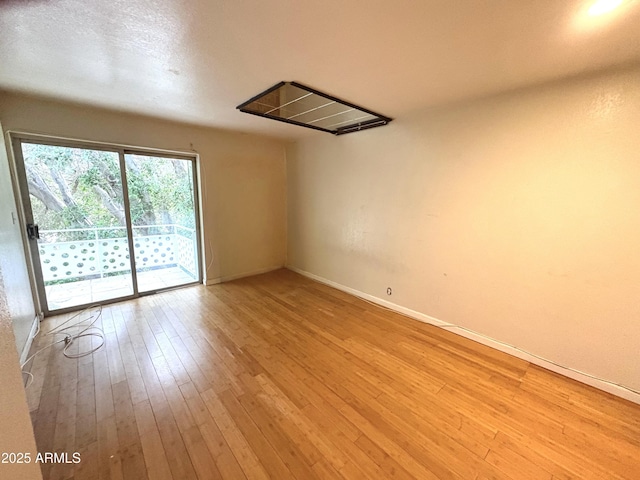 1702 W Tuckey Ln Unit 209, Phoenix, AZ 85015 - unfurnished room with hardwood / wood-style floors and baseboards