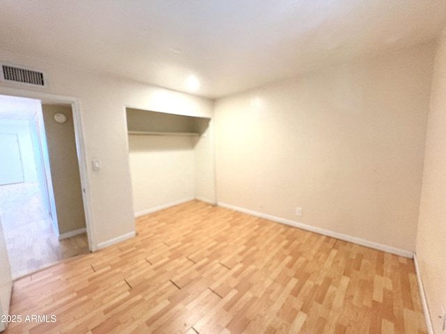 1702 W Tuckey Ln Unit 209, Phoenix, AZ 85015 - unfurnished bedroom with light wood-style flooring, baseboards, and a closet
